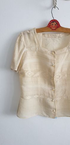 "Vintage 1930s -1940s raw silk thread known in Romania as borangic blouse with square neckline, short sleeves and closes with snaps. -- M E A S U R E M E N T S --- fits like: small/ medium bust: 38\" waist: 33\" length: 22\" brand/maker: n/a condition: excellent see last photo Shipping Is Avaliable Worldwide. Every item is carefully shipped Priority via Air Mail - shipping takes from 7 to 14 working days, depending on your location. Shipping includes Tracking. Come and check out our shop to see Fitted Vintage Fashion Summer Blouse, Vintage Linen Tops For Daywear, Vintage Square Neck Blouse For Spring, Vintage Square Neck Blouse For Summer, Fitted Cream Linen Blouse, Fitted Linen Cream Blouse, Vintage Beige Linen Blouse, Vintage Linen Blouse For Summer, Vintage Summer Blouse With Buttons