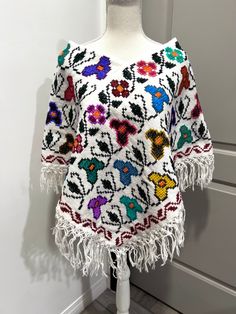 Beautiful Mexican Mañanitas in different colors and designs. Handmade by talented artisans in Mexico. This beautiful poncho will have your amigas complementing you! These are definitely a must-have for the holidays.These are all one-size. It fits Small, Medium and Large.Hermosas Mañanitas Mexicanas en diferentes colores y diseños. Hecho a mano por talentosos artesanos en México. Este hermoso poncho hará que tus amigas te complementen todas las veces! Definitivamente son imprescindibles para las Cotton Shawl Poncho, Multicolor One Size Poncho For Vacation, Casual Multicolor Poncho For Vacation, Handmade Multicolor Casual Patterns, Bohemian Shawl Patterns For Winter, Hippie Multicolor Poncho For Beach, Handmade Bohemian Multicolor Tops, Handmade Multicolor Bohemian Tops, Handmade Multicolor Tops For Vacation