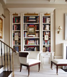 a living room filled with lots of books and furniture