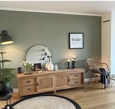 a living room filled with furniture and a large mirror on top of a wooden table