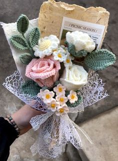 a bouquet of flowers is being held by someone's hand