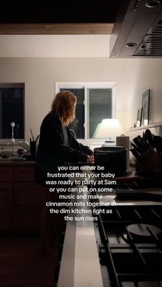 a woman sitting at a kitchen counter in front of an oven