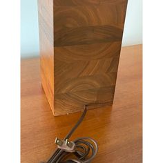 a cord connected to a wooden box on a table