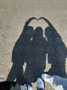 the shadow of two people standing next to each other