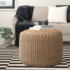 a living room with a white couch and black and white rug