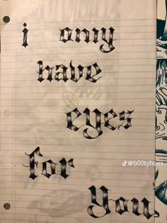 some type of writing that is on top of a piece of paper with black ink