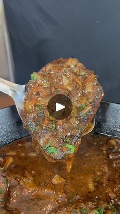 a large pot filled with food on top of a metal pan covered in broth