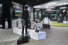 the golf shop has many different types of clothing and equipment on display, including two mannequins