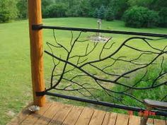 a wooden bench sitting on top of a deck next to a lush green park filled with trees