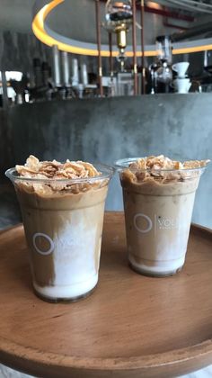 two cups filled with food sitting on top of a table