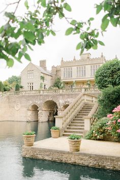 there is a large building with stairs leading up to it and flowers in the foreground