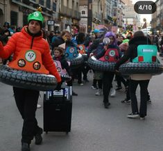 a group of people walking down a street with inflatables