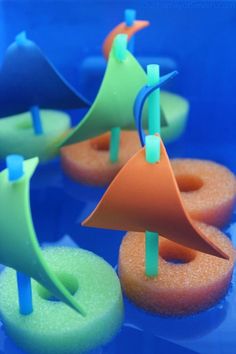 several donuts with colorful icing on them are arranged in the shape of an orange cone