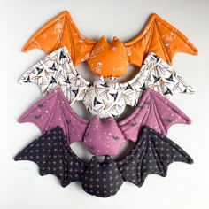 an orange, purple and black bat hanging on the wall