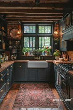 a kitchen with wooden floors and black cabinets, an area rug on the floor in front of the window