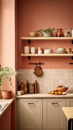 a kitchen with pink walls and shelves filled with dishes