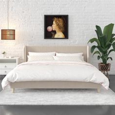 a bedroom with white brick walls and an art work on the wall above the bed