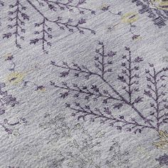 close up view of an embroidered fabric with flowers and leaves on the side, as if it were made from wool or silk