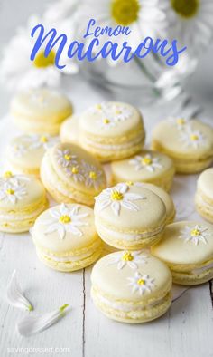 lemon macaroons on a white table with daisies in the background and text overlay that reads lemon macaroons