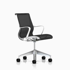 a black and white office chair sitting on top of a metal frame base with wheels