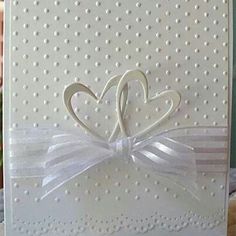 a close up of a card with a heart and ribbon on the front that says love