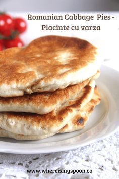 three pancakes are stacked on a white plate with cherry tomatoes in the backgroud