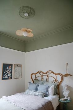 a bed sitting in a bedroom under a ceiling fan