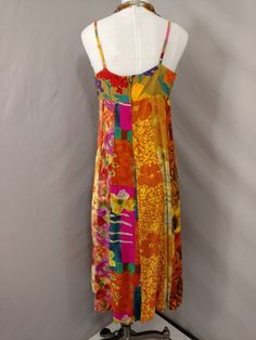 "Wonderful color and feminine styling on this vintage dress. The label is Jams World, and Falls Garden, circa nineties. Fabric content 100% rayon Made in Hawaii, USA. Fabric has a very nice feel. Shape is feminine, sleeveless, with spaghetti straps. Hem circumference is 88\". Dress length is 48\" long. Bust - armpit circumference is 37\", bodice is lined with the same fabric. Please convo me for any additional details or photos you would like. Marked size L but it is not a contemporary large Not Casual Multicolor Silk Maxi Dress, Multicolor Silk Sundress, Vintage Silk Beach Dress, Vintage Silk Dress For The Beach, Summer Silk Patchwork Dress, Retro Multicolor Maxi Dress For Garden Party, Vintage Multicolor Floral Print Dress, Retro Multicolor Midi Beach Dress, Retro Multicolor Midi Dress For Beach