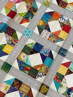 a patchwork quilt with many different colors and designs on it's sides,