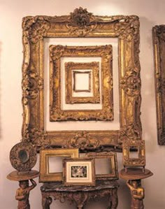 an ornate gold frame is on display next to other antique items