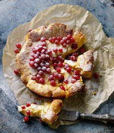 cranberry and white chocolate danish pastries on top of wax paper next to a knife