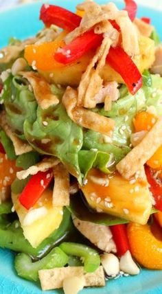 a blue plate topped with salad and vegetables