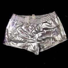 Silver Shorts W/ Pockets Stretch Shiny Short Bottoms, Metallic Shiny Stretch Shorts, Metallic Stretch Disco Shorts, Metallic Disco Shorts For Summer, Shiny Summer Shorts, Glamorous Shiny Summer Bottoms, Shiny Stretch Bottoms For Summer, Shimmer Bottoms For Night Out In Summer, Shimmer Bottoms For Summer Night Out