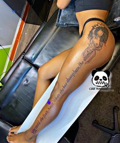 a woman sitting on top of a surfboard with her legs crossed and tattooing