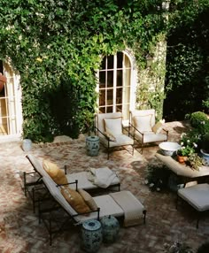 an outdoor living area with couches and chairs