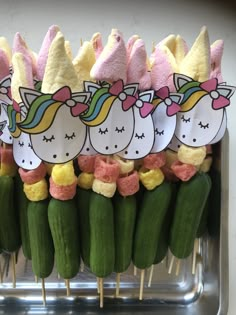 there are many little unicorns on cucumbers with toothpicks attached to them