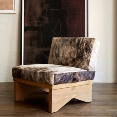 a chair that is sitting in front of a painting