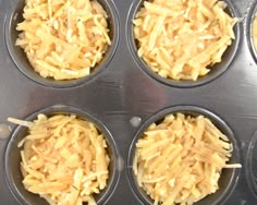 four muffin tins filled with cheese on top of a stovetop oven counter