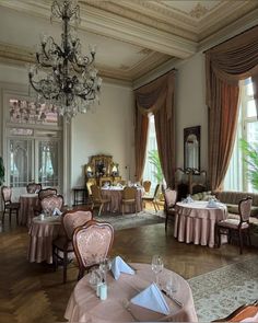 a fancy dining room with chandeliers and tables