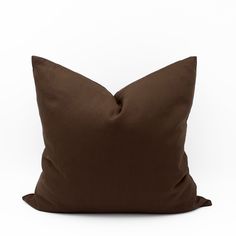 a brown pillow on a white background