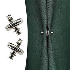 two metal buttons are attached to the side of a green suit jacket with silver pins