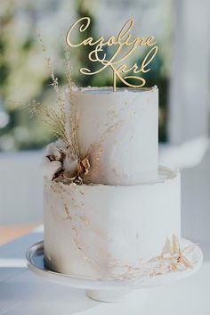 a white cake with gold decorations on top