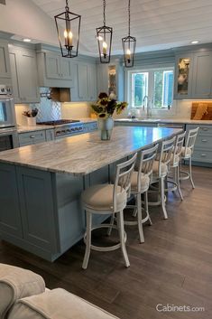 a large kitchen island with chairs around it