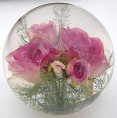 some pink flowers in a clear glass vase