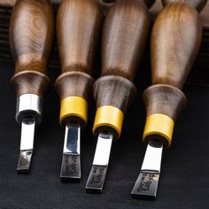 four different types of wood carving tools sitting next to each other