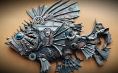 an intricately designed piece of metal on a brown surface with blue eyes and spikes