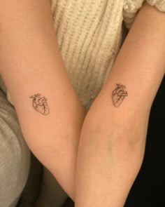 two people with matching tattoos on their arms