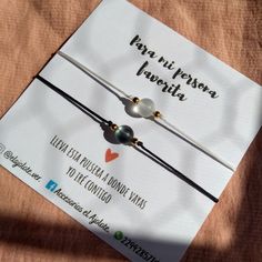 two bracelets with pearls are sitting on top of a card that says papa nu pestora jaquita