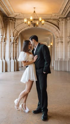 a man and woman are standing in an archway