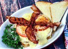 a plate with bacon, eggs and toast on it